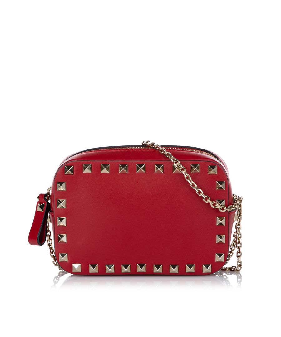 VINTAGE. RRP AS NEW. This crossbody bag features a leather body, silver-tone rockstud embellishments, a flat strap, and a top zip closure.\n\nDimensions:\nLength 14cm\nWidth 18cm\nDepth 6cm\nShoulder Drop 54cm\n\nOriginal Accessories: Dust Bag, Dust Bag, Authenticity Card\n\nColor: Red\nMaterial: Leather x Calf\nCountry of Origin: Italy\nBoutique Reference: SSU173366K1342\n\n\nProduct Rating: GoodCondition\n\nCertificate of Authenticity is available upon request with no extra fee required. Please contact our customer service team.