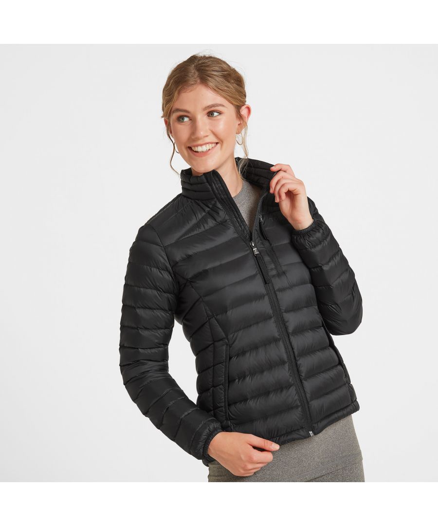 Perfect for adding a layer of warmth without any bulk, our Drax down filled womens jacket is soft and silky to the touch, incredibly light and packs down small into a zip up inside pocket. You'll have no trouble finding room for it in your case when you go away, and it also makes a handy travel pillow. This padded jacket gets its incredible warmth from naturally insulating duck down that traps heat without being bulky. Sleek panelling and a high neck creates a flattering fitted silhouette and it feels as good as it looks with details like a soft chin cover over the top of the zip. Designed to squish down really small, then spring back into shape, Drax has roomy side pockets protected by an elasticated flap, light elastic at the cuffs and small toggle adjusters at the hem keep the chill out. Designed in Yorkshire, where we always need layers, our Drax womens jacket is ideal for wearing over a top when it's only a bit chilly or layering under a coat when the wind is howling. Reflecting our Spen Valley ethos of Truth Over Glory, it has a TOG24 logo proudly printed on the chest.