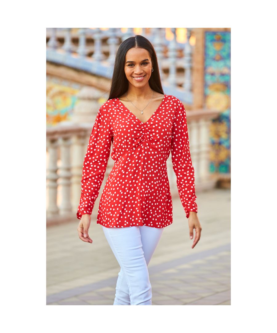 REASONS TO BUY: \n\nThat feeling when you find a top that's comfy and stylish\nMood-boosting red spot print\nEmpire line design drapes softly over the body\nRuched V-neck and longline hem for a flattering fit\nRuched sleeves, because it's the little details that matter\nPerfect with skinnies and heels