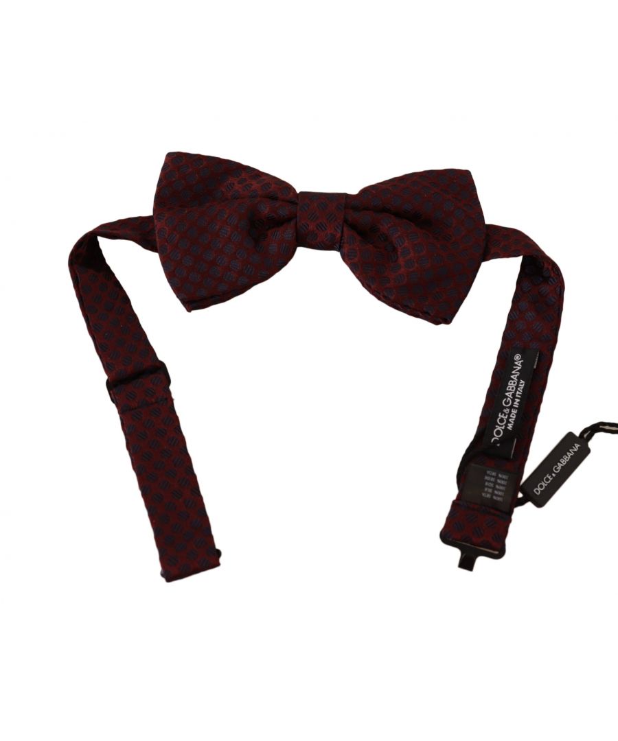 DOLCE & GABBANA\nAbsolutely stunning, 100% Authentic, brand new with tags bow tie. The masters of the brand added a small metal clasp in the form of a hook on the back of the model.\nThis item comes from the exclusive collection.\nColor: Maroon with dots pattern\nModel: Tied\nMaterial: 100% Silk\nAdjustable length neck strap, one size\nMade In Italy