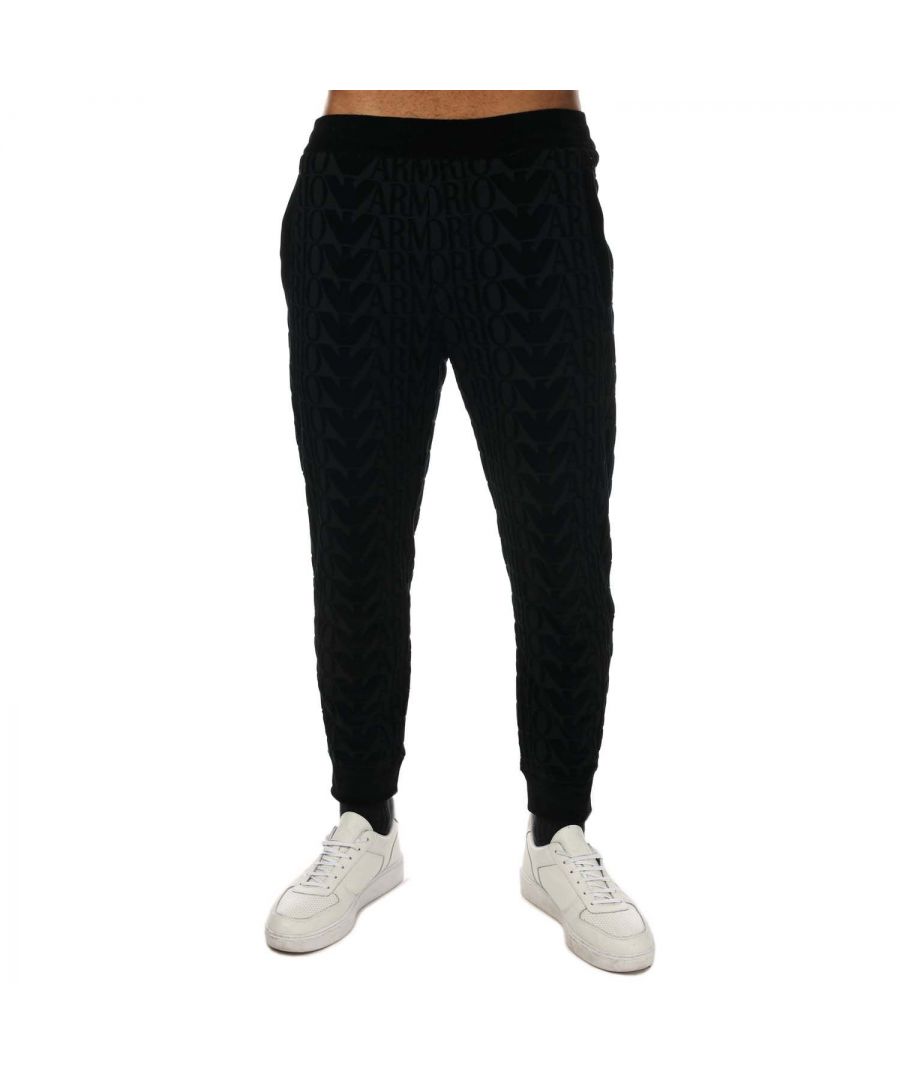 Mens Armani All Over Logo Trousers in black.- Elasticated waistband.- Two side pockets.- Flocked logo.- All-over logo print.- Cropped.- Elasticated waistband.- Fabric: 84% Cotton  16% Polyamide.- Ref: 6L1P99JWZ0F025