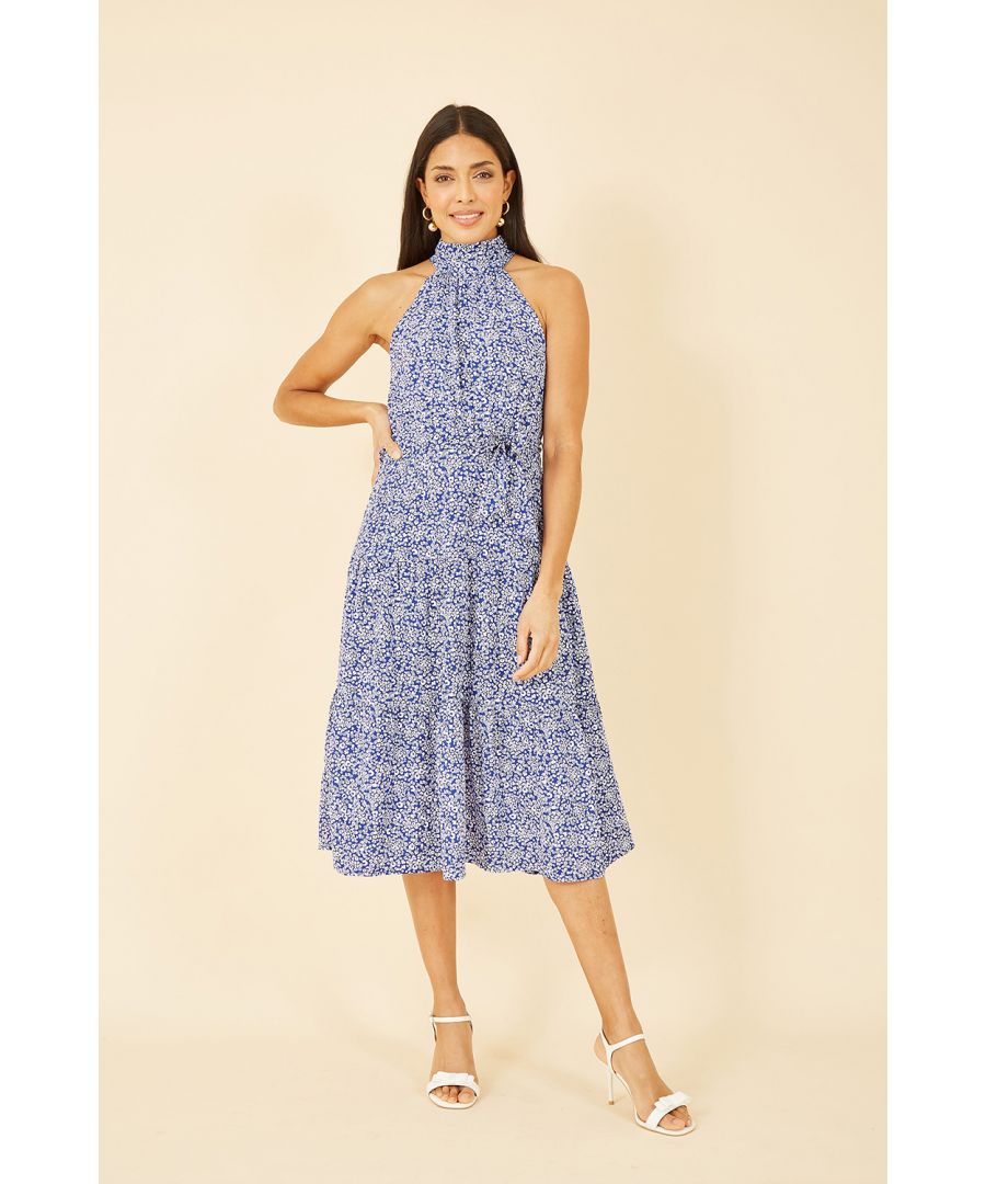 Looking to update your holiday wardrobe? Look no further! With a all over print in blue and white, this Mela midi dress is suitcase ready. With a halter neck, self tie waist and tiered flowy skirt, we love it styled with chunky sandals and sunglasses for cocktails at sunset.