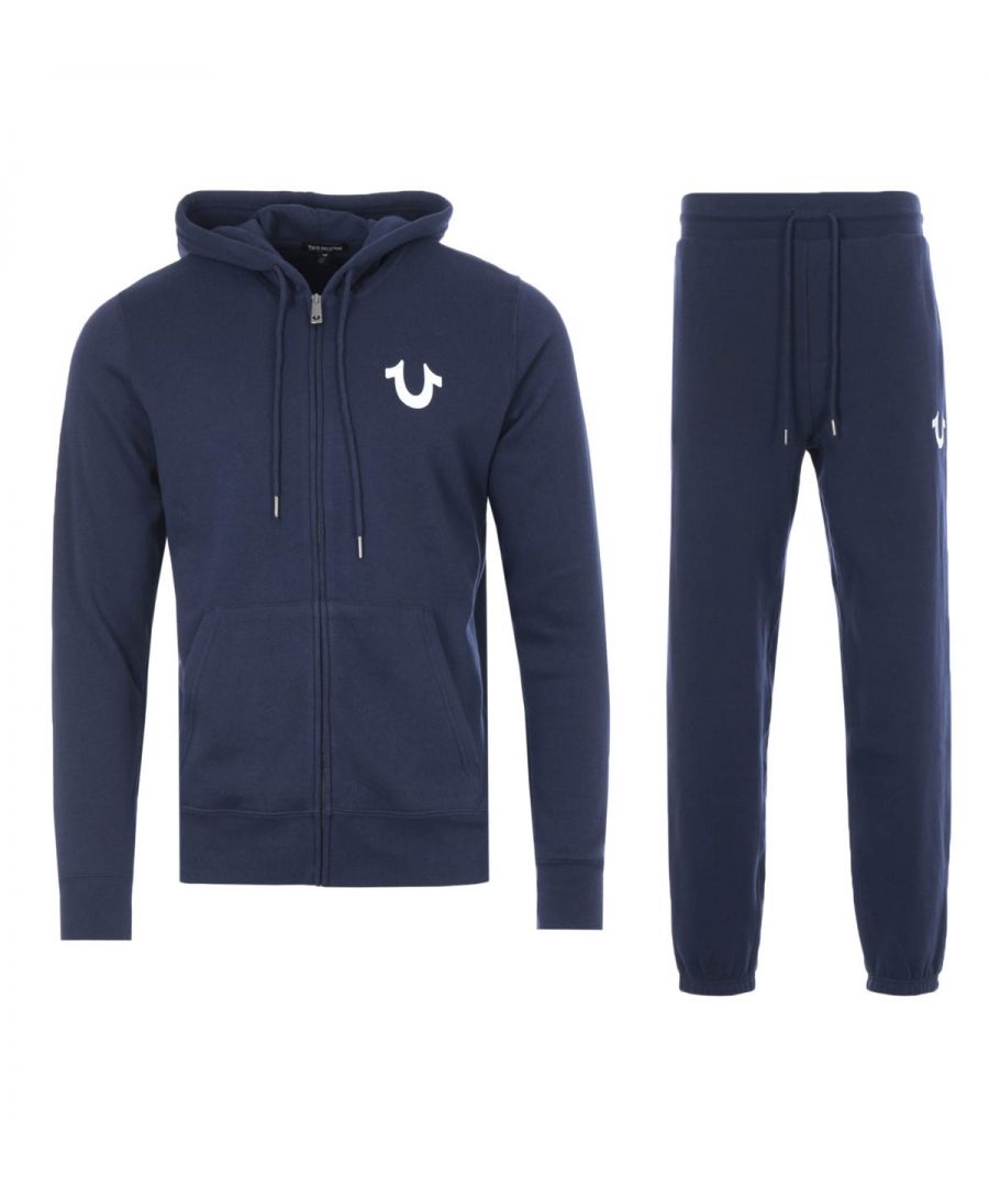 The Lullaby Hooded Sweatshirt Tracksuit Set from True Religion boasts their bold designs with supreme comfort. Both pieces have been crafted from a soft cotton blend providing comfort and breathability. The joggers are fitted with a drawstring waist and elasticated cuffs, whilst the hoodie is fitted with a drawstring hood, split kangaroo pocket and a full zip closure. Both finished with iconic True Religion branding.Regular Fit, Cotton Blend Composition, Zip Up Hooded Sweatshirt, Drawstring Joggers, True Religion Branding. Style & Fit:Regular Fit, Fits True to Size. Composition & Care: 60% Cotton, 40% Polyester, Machine Wash.