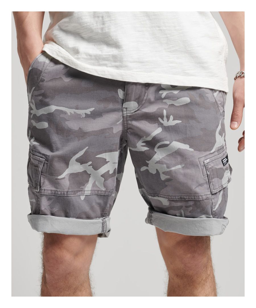 Superdry men's Core cargo shorts. These classic cargo shorts feature a zip and button fly fastening, two open front pockets with an extra coin pocket, two thigh pockets, two rear pockets, and belt loops. Finished with a Superdry logo on one thigh pocket, and a Superdry logo patch on the back.Relaxed fit – the classic Superdry fit. Not too slim, not too loose, just right. Go for your normal size