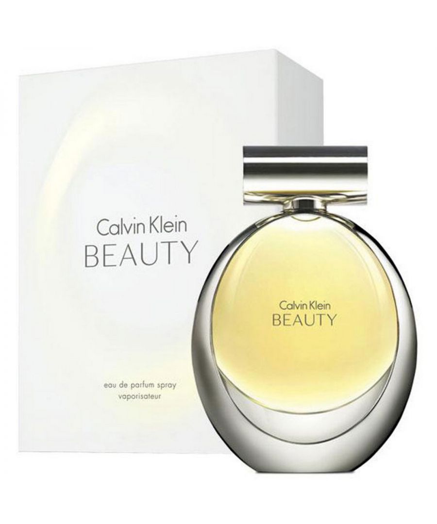 Calvin Klein Beauty Eau de Parfum Spray 100ml evokes the ultimate power of femininity and sophistication, while capturing the spirit of a woman who is beautiful from the inside out, with an aura that radiates. A new interpretation of a lily - a neo-lily - is the heart and soul of Calvin Klein Beauty. A sophisticated flower that is the essence of femininity, the lily is also radiant and powerful. Bringing the neo-lily to life, ambrette seeds enhance the spicy warmth, timeless jasmine elevates the floral signature, and a trail of cedarwood brings a vibrant and magnetic beauty to the drydown.