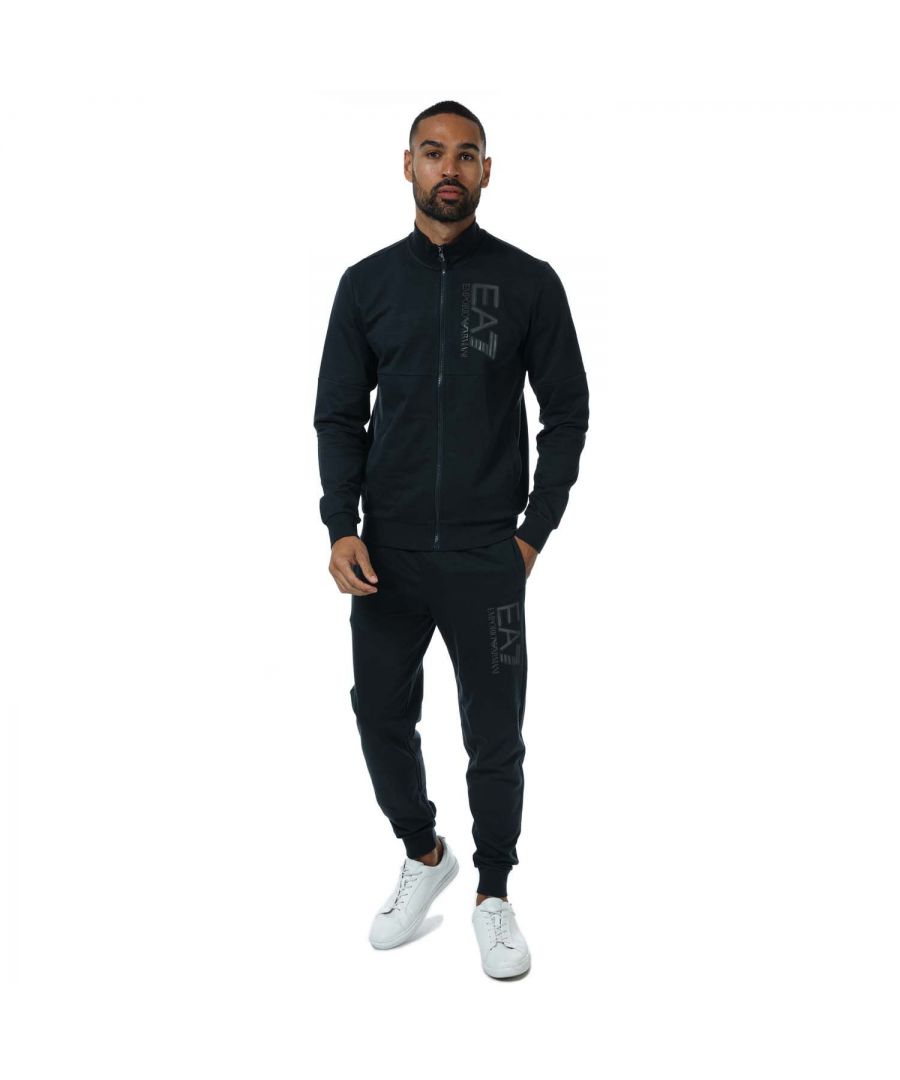 Mens Emporio Armani EA7 Train Visibility Tracksuit in navy. Top:- Funnel neck collar.- Long sleeves.- Zip fastening.- Emporio Armani EA7 logo on the chest.- Ribbed cuffs and hem.- Fabric: 100% Cotton. Rib Details: 97% Cotton  3% Elastane.- Bottoms:- Elasticated waist with inner drawcord.- Two open side pockets.- Ribbed finishes.- Emporio Armani EA7 branding to the leg.- Fabric: 100% Cotton. Rib Details: 97% Cotton  3% Elastane.- Ref: 6KPV53J05Z1578