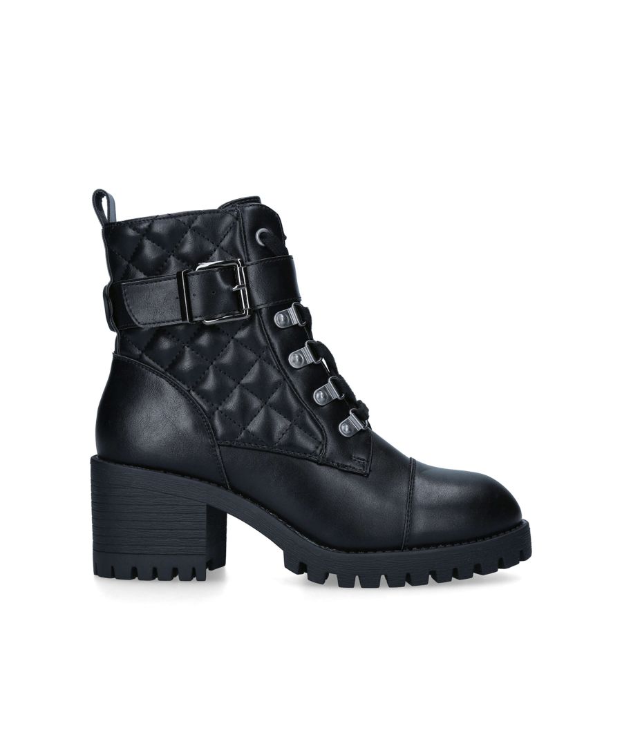 The Tata ankle boot features a black quilted upper with a buckled strap across the ankle. There is a KG Kurt Geiger black rubber branded monocle on the back of the ankle.