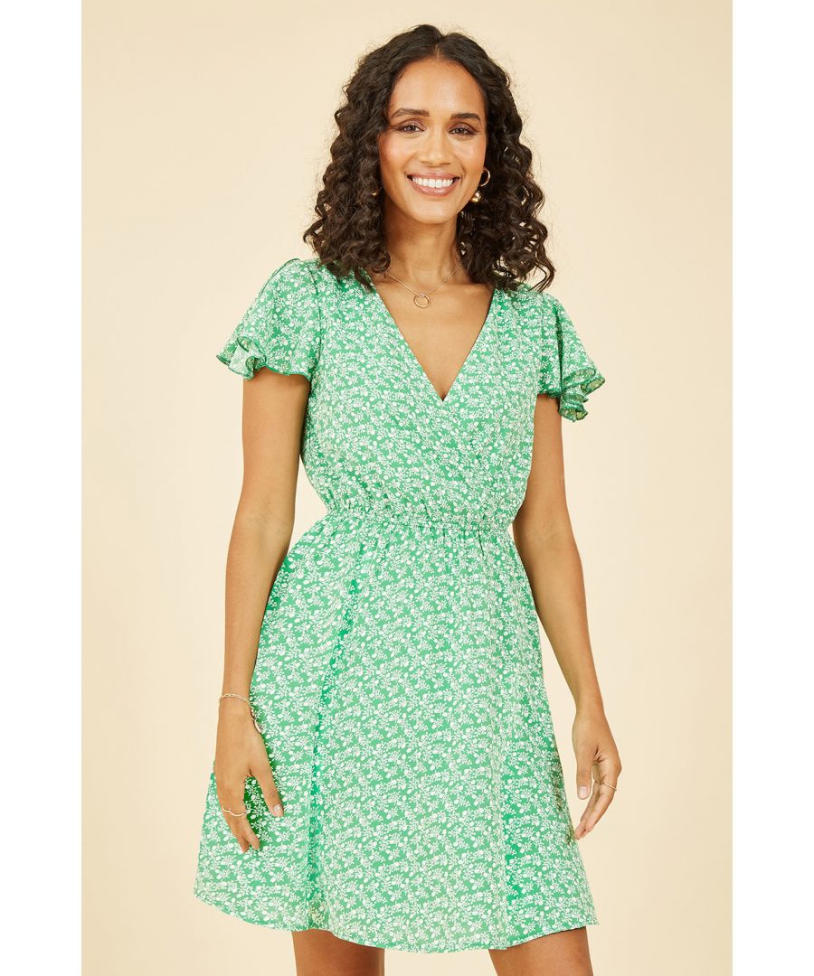Skip into the summer in this Mela Green Ditsy Print Wrap Skater Dress. Perfect for warmer weather, this dress features a knee skimming design, and short sleeves. We love this piece paired with a simple denim cropped jacket. The all over ditsy print is the perfect way to bring some cute interest to your everyday fit.