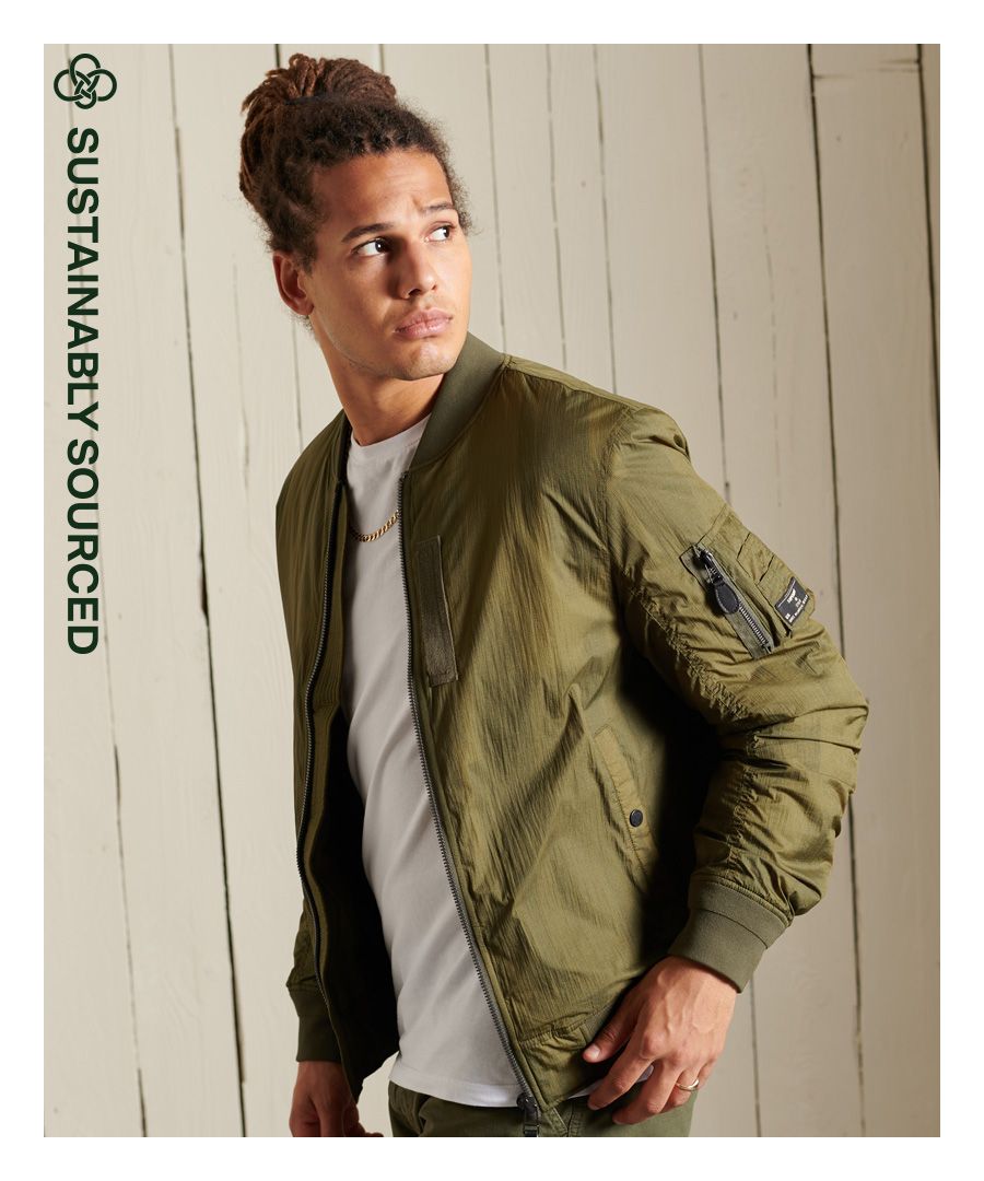 Our own take on a classic, the Military MA1 Bomber jacket draws inspiration from that namesake 1950s flight jacket. Using lightweight textured fabric and sustainable recycled filling, the heritage design of the MA1 is brought squarely up to date, allowing you to style the way you like to give you a distinctive informal look.Relaxed fit – the classic Superdry fit. Not too slim, not too loose, just right. Go for your normal sizeRecycled paddingZip fasteningRibbed elasticated collarFront popper pocketsZipped sleeve pocketWebbing strap detailingQuilted liningInside pocketLeather zip pullerThe padding in this jacket is 100% recycled, each jacket contains up to 20 recycled bottles, this avoids these bottles being sent to landfill or polluting our oceans.
