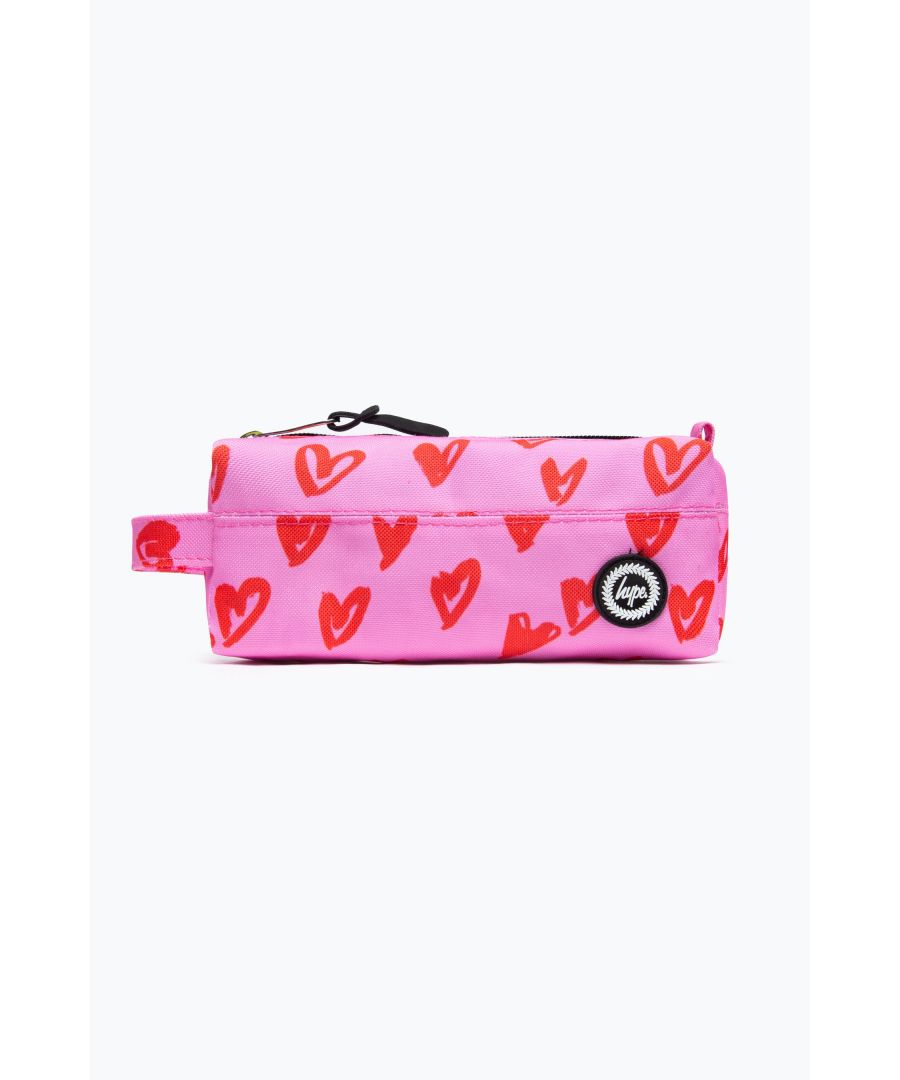 Meet the HYPE. Pink & Red Hearts Pencil Case, part of the HYPE. 2022 Back to School collection. The perfect home for your stationery, pencils, pens, rulers, highlighters, and more. Featuring a sublimated pink and red heart print, rubber HYPE. crest branding, and rubber zip puller. Bundle up with the matching backpack to start the school year in style.