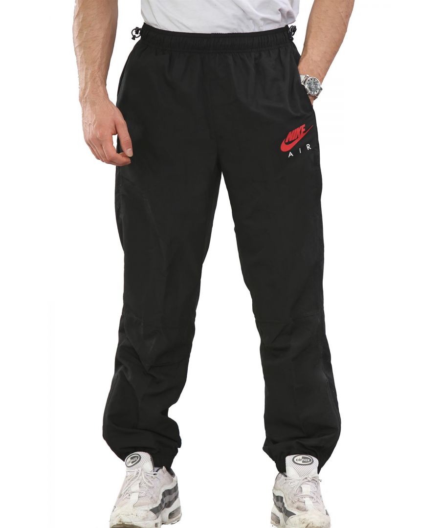 Nike Air Mens Light Weight Woven Track Pants.  \nThey've Got an Elastic Waistband With Drawstring Closure on Both Sides of the Waist for Ultimate Comfort Support.  \n2 Hand Pockets,  Additional Secured Zip Pocket on the Left Leg.   \nElastic Waistband at the Ankles With Zip Closure Details Going Down Both Sides.   \nPerforated Stripes and a Breathable Mesh Lining for Comfort.  \nOther Details Include a Contrast Nike Air Swoosh and Logo Embroidery on Left Thigh.  \nLarge Contrast Nike Air Wordmark on Back of Lower Right Leg.  \nLogo and Nike Air Tab Red Stitching on Back of Upper Right Leg.\nIdeal for Training and Daily Activities.