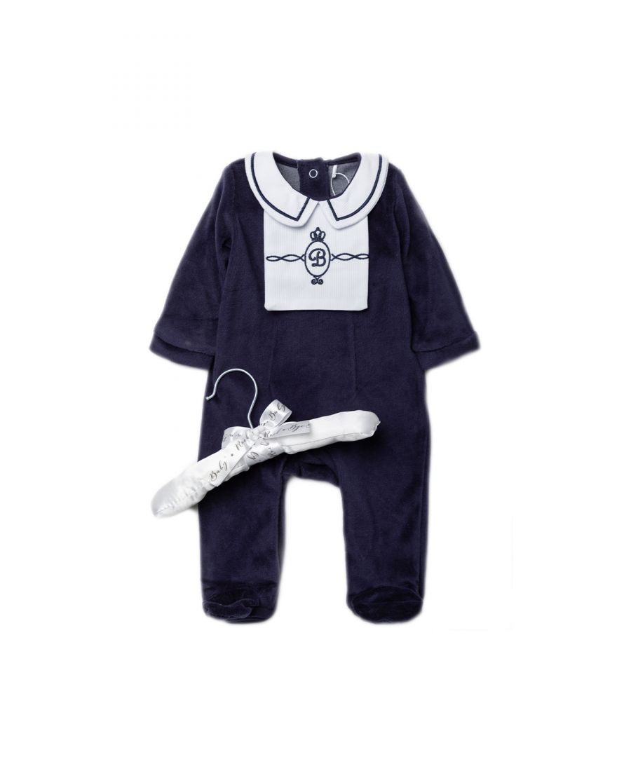 This adorable Rockabye Baby Boutique navy, velour sleepsuit features lovely embroidery details. The sleepsuit is footed, with popper fastenings, with an adorable smocking style collar. The set is cotton, keeping your little one comfortable. This set comes with a satin hanger, making a lovely baby shower gift for the little one in your life!