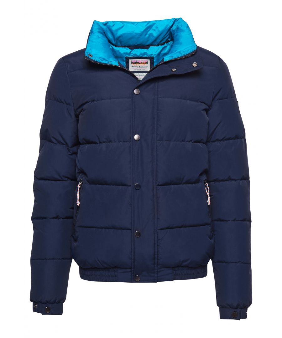 For a retro vibe, the Source Retro Puffer Jacket offers both bold style and great comfort.Relaxed fit – the classic Superdry fit. Not too slim, not too loose, just right. Go for your normal sizeZip and popper fasteningTwo pocketsPopper cuffsElasticised cuffs and hemSingle inner pocketSignature logo patchThe padding in this jacket is 100% recycled, each jacket contains up to 30 recycled bottles, this avoids these bottles being sent to landfill or polluting our oceans.