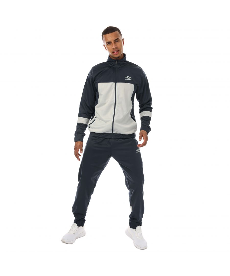 Mens Umbro Diamond Alliance Poly Tracksuit in navy.- Jackets:- Reverse coil zip puller.- Side slip pockets.- Zip fastening.- Contrast sleeve & front panel.- Elasticted cuff and hem.- 100% Polyester.- Bottoms:- Grown on waistband with inner drawcords.- Slide slip pockets.- Back pocket.- Contrast panels to rear leg.- Transfer print to leg.- Elasticted cuff.- Zips to side leg.- 100% Polyester.- Ref: UMJM0638NRUNAV