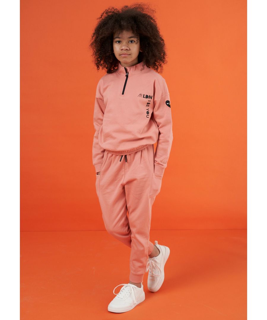 Get ready to boss it casual style in our new tracksuit top. Made in the softest brushed back cotton sweat  with a quarter zip neck with branded logo details . Wear with our matching tracksuit bottoms and fresh kicks to complete the look  Model wears 11y  she is 10 years old and 137cm tall.  Angel & Rocket cares - made with Fairtrade cotton  Colour: Pink  100% Cotton  Look after me: Think planet  wash at 30c