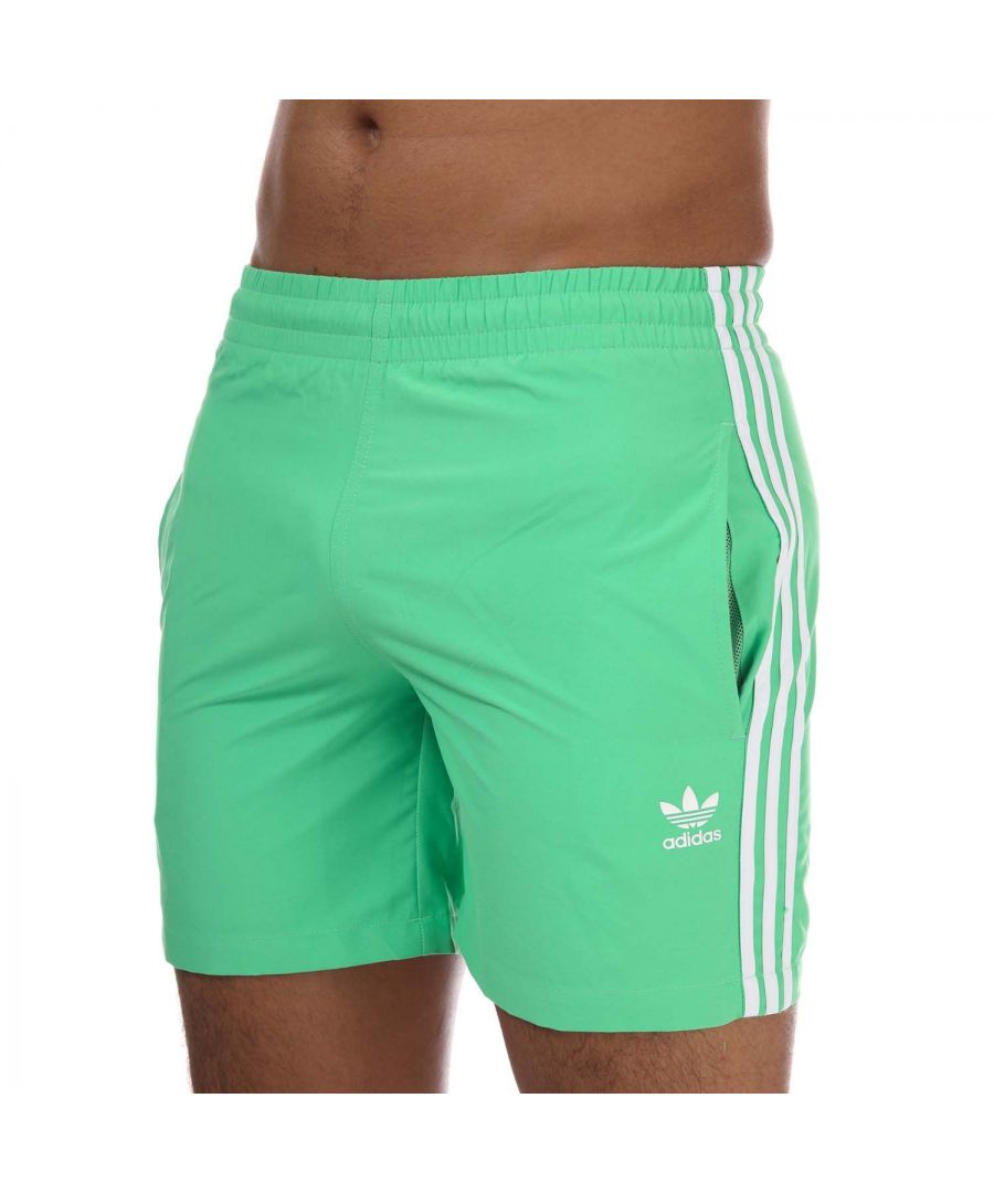 Mens adidas Originals Adicolor Classics 3- Stripes Swim Shorts in semi-screaming green.- Drawcord on elastic waist.- Side pockets.- Mesh lining.- Regular fit.- Shell: 100% Polyester (Recycled). Inner Brief: 100% Polyester (Recycled). - Ref: H06702