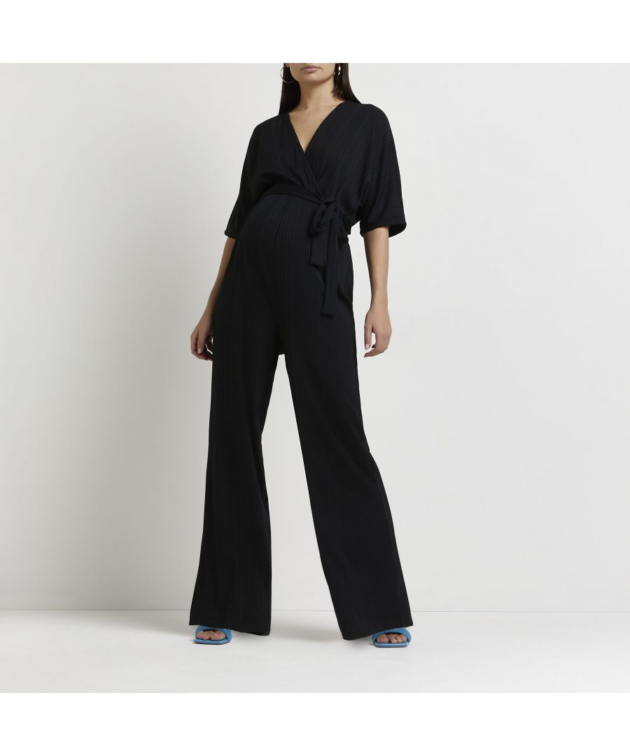 > Brand: River Island> Department: Women> Colour: Black> Type: One-Piece> Style: Jumpsuit> Size Type: Maternity> Material Composition: 96% Polyester 4% Elastane> Material: Polyester> Fit: Regular> Pattern: No Pattern> Occasion: Casual> Season: SS22> Sleeve Length: Short Sleeve> Neckline: V-Neck> Leg Style: Wide-Leg