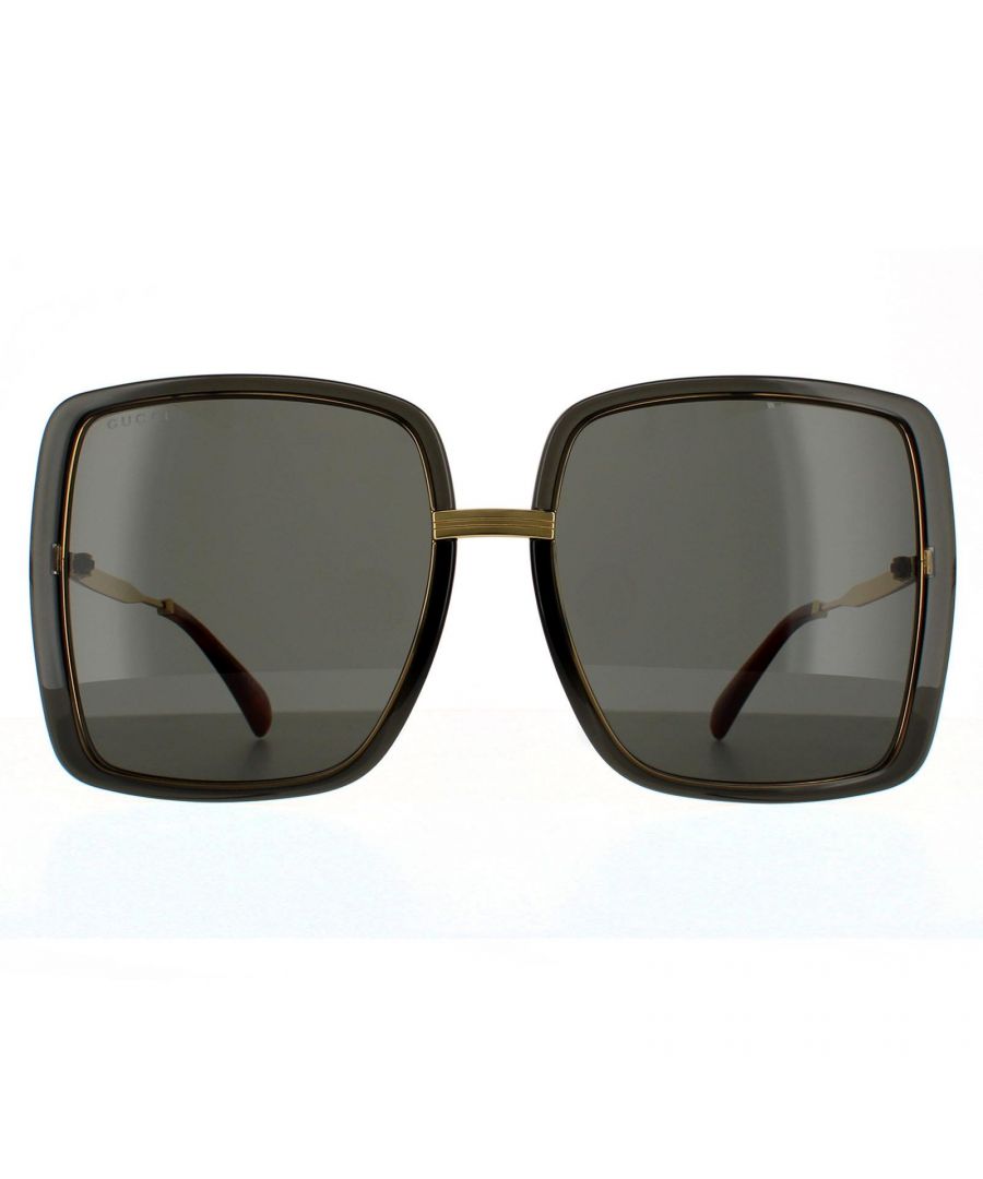Gucci Square Womens Grey Crystal and Gold  Grey Sunglasses Gucci have super oversized square lenses with plastic rims and contrasting slim metal temples and bridge. Stripes are engraved into the  metal, as well as the Gucci logo on the temples.