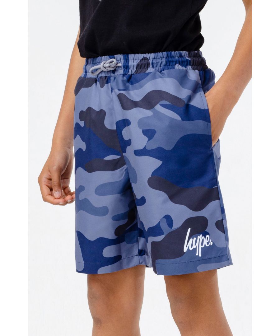 Meet your new Summer wardrobe staple, the HYPE. Boys Blue Camo Swim Shorts, perfect for those beach or poolside days. Designed in a 100% Polyester fabric base for the ultimate comfort, featuring an elasticated waistband, drawstring pullers, and an all-over blue camo print. Finished with the HYPE. mini script logo in contrasting white. Wear with a pair of HYPE. sliders and sunglasses to complete the look. Machine wash at 30 degrees.