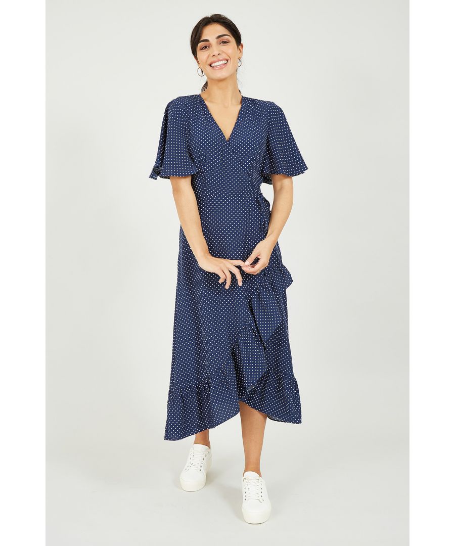 Update your favourite prints with this stylish Mela Navy Spotted Wrap Midi Dress. Framed by classic short sleeves and a modern asymmetric hemline, it features voluminous ruffles running from the waist to hemline. For the perfect finishing touch, look to the lightweight fabric and pretty polka dot print.