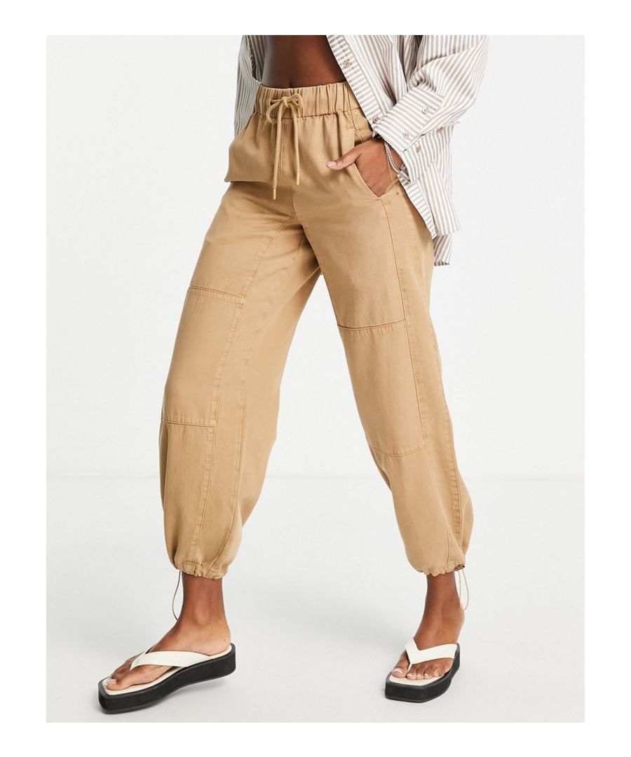 Trousers by Topshop The scroll is over High rise Drawstring waist Side pockets Toggle cuffs Regular fit Sold by Asos