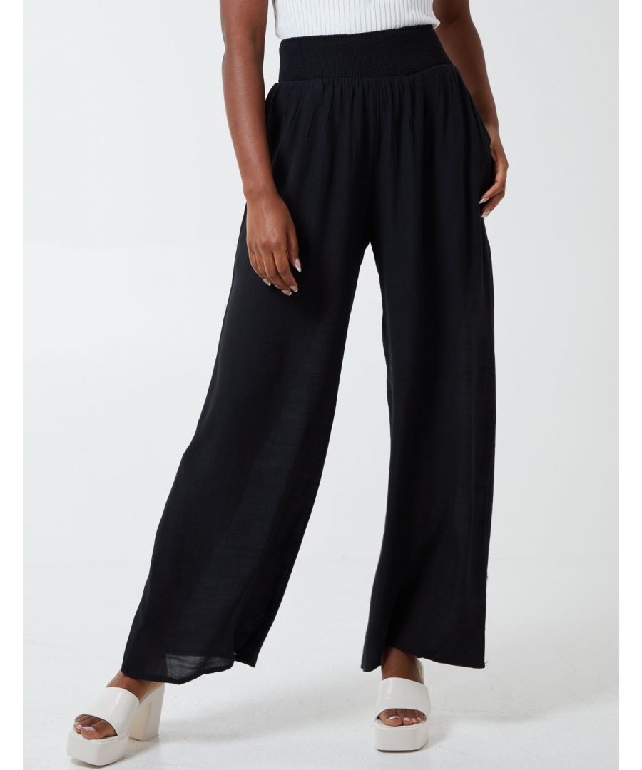 Go for comfort with this wide leg elastic waist trouser. It will be your fav new staple! Wear in the office, to pick up the kids, a comfy day at home, or out on the town. This versatile piece could be worn with trainers and a comfy knit or dress it up with a glitzy top and heels! \n64% Viscose, 36% Polyester Made in ChinaHand wash        Elasticated waist UnfastenedApprox length 108cmModel wearing SModel height: 5'8