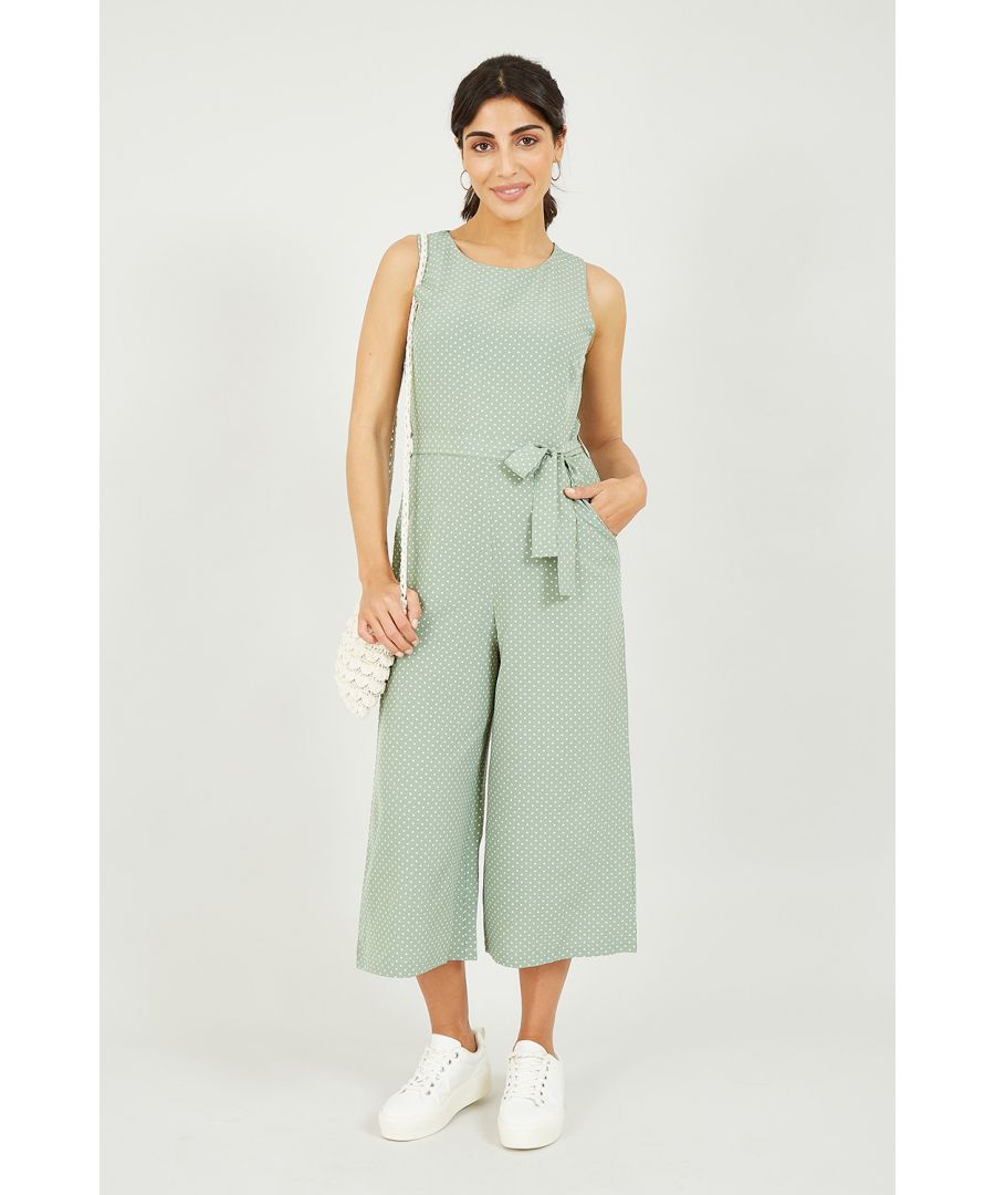 The perfect partner to a cropped denim jacket, this sleeveless Mela Polka Dot Culotte Jumpsuit can be styled up or down. Think workwear, evening wear, a cool and casual day time fit - this piece really does do it all. With a flattering and classic green and white polka dot design, a sleeveless finish and a cinched waist, it's hard not to look your best.