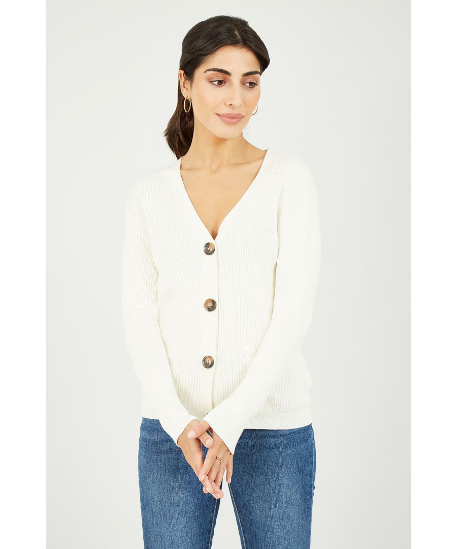 Upgrade your wardrobe staples with this high quality, soft cream ribbed v-neck knitted cardigan by Yumi. The perfect basic fit, this super soft, stretchy cardigan features vertical ribbing and large tortoiseshell button fastenings. A versatile fit, easy to wear multiple ways - we love this cardigan styled with wide legged trousers and boots.