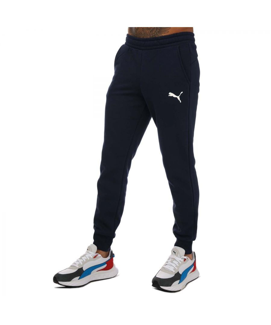 Mens Puma Essentials Logo Sweatpants in navy.- Elasticated waist with inner drawcord.- Two front pockets.- Ribbed ankle cuffs.- Printed branding.- Brushback fleece.- Regular fit.- Shell: 66% Cotton  34% Elastane. Rib: 97% Cotton  3% Elastane.- Ref: 58671476