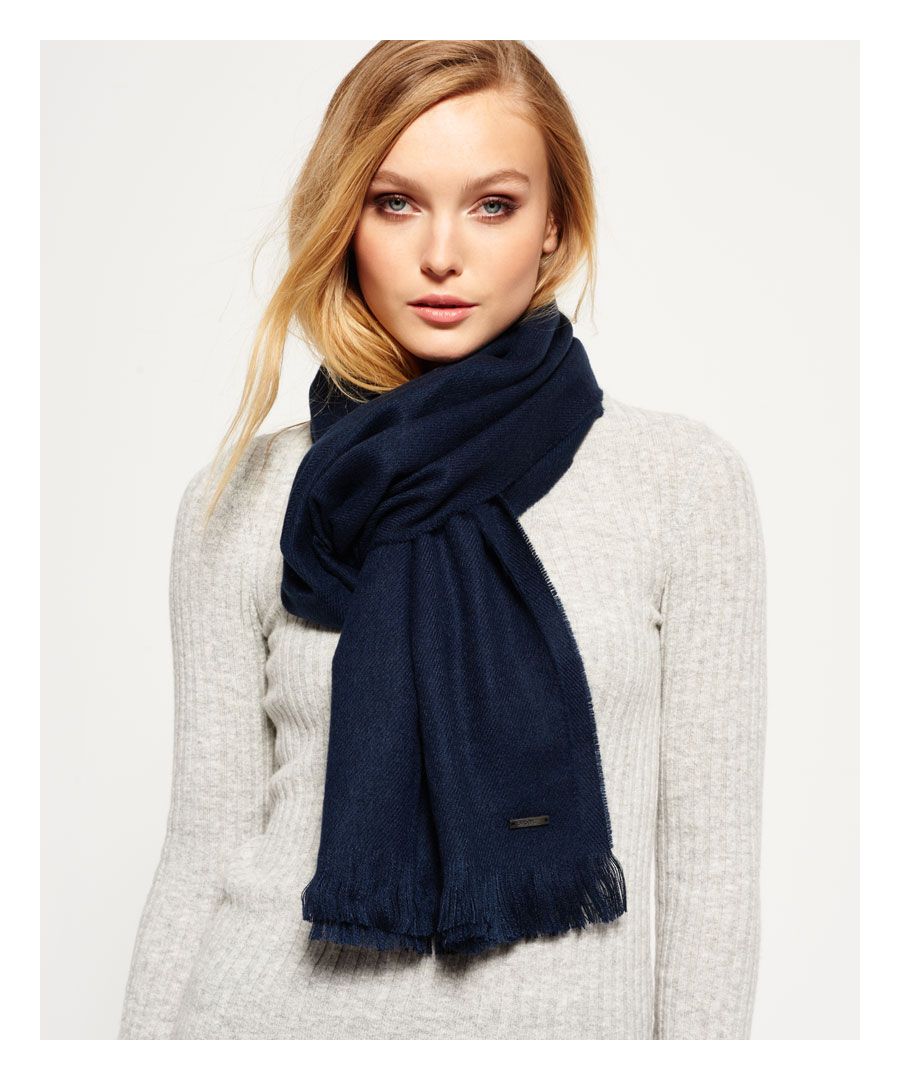 Superdry women's solid Capital fringe scarf. A lightweight scarf featuring frayed ends and finished with a small metal Superdry badge near the hem.