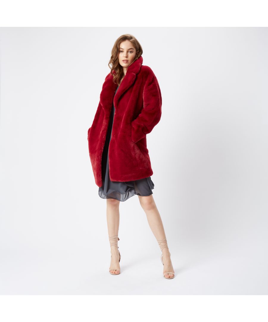 Featuring the softest, cosy faux fur, side slanted pockets and oversized lapel, this faux fur coat will keep the winter chill at bay this Winter. Finished with hook and eye fasteners, falling above the knee, wear with chunky boots and jeans for a chic off duty look.