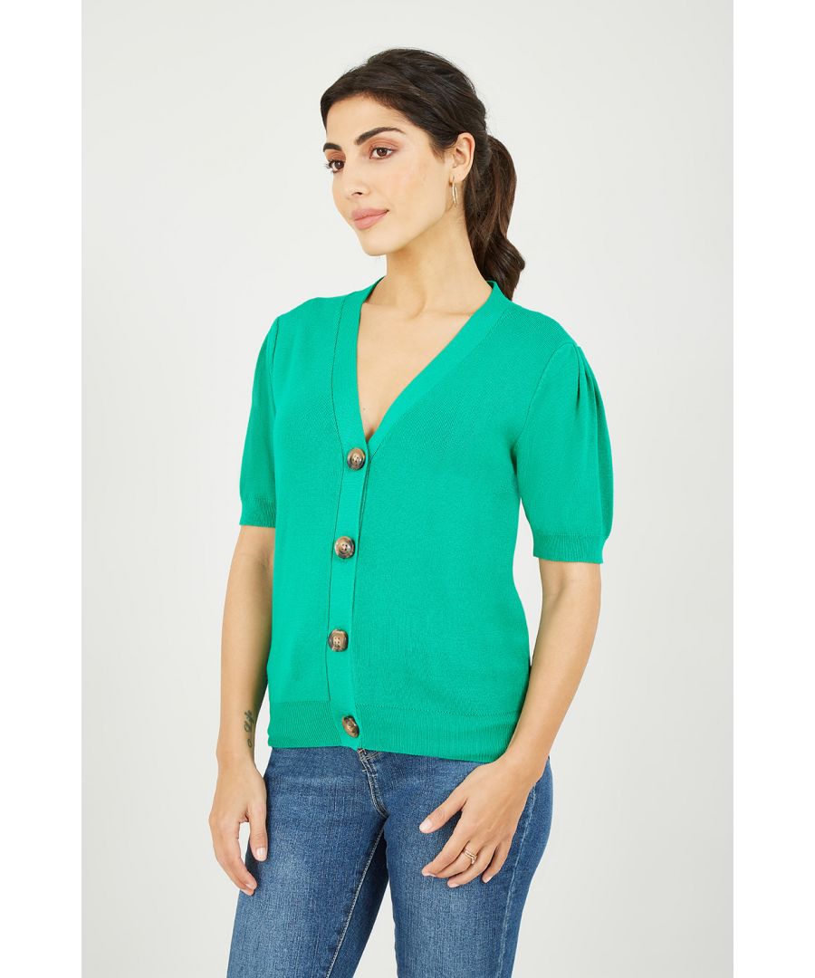 Stock up on short sleeve essentials with this stunning Yumi Green Short Sleeve Knitted Cardigan. Perfect for layering, this knitwear staple come in a striking bright Green, with subtle vertical ribbing, balloon sleeve style short sleeves and tortoiseshell button fastenings.