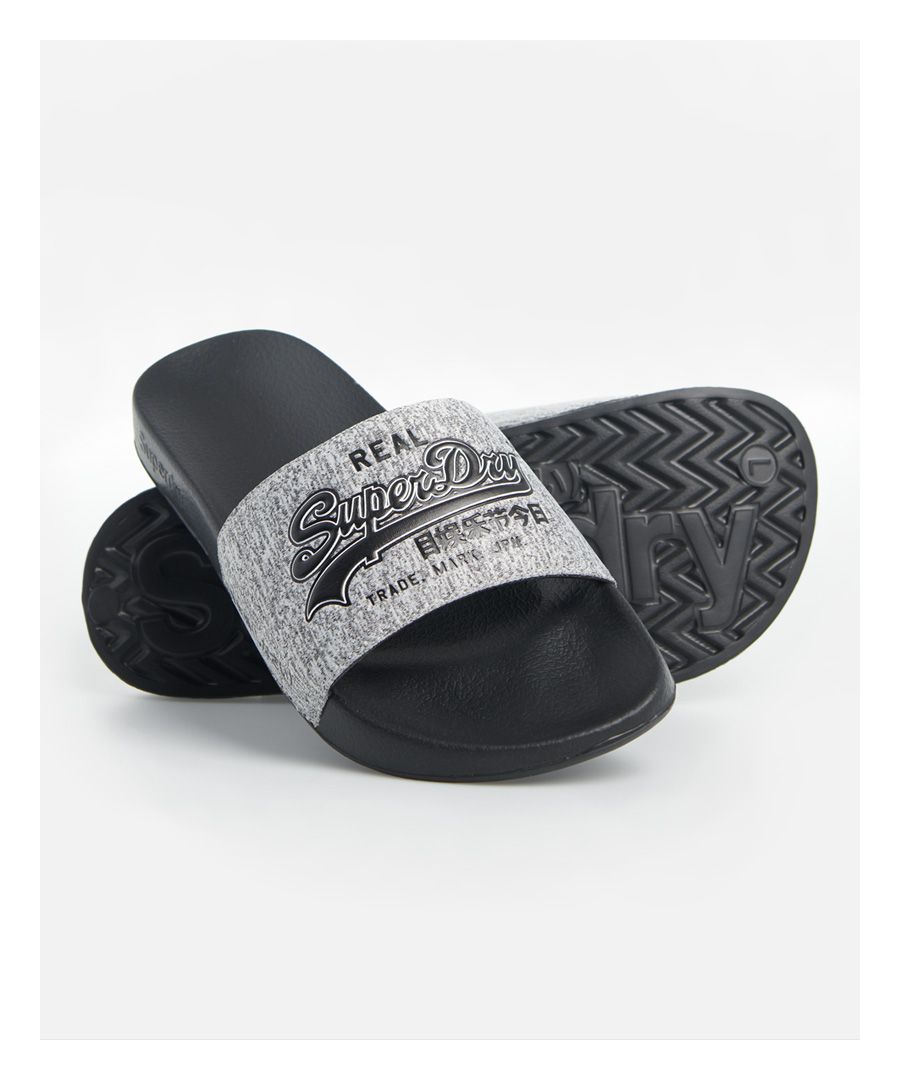 Superdry men's Vintage Logo pool sliders. These sliders feature a wide, padded strap and moulded food bed for added comfort. Finished with a textured Superdry logo across the strap and Superdry logo on the sole.S - UK 6-7, EU 40-41, US 7-8M - UK 8-9, EU 42-43, US 9-10L - UK 10-11, EU 44-45, US 11-12XL - UK 12-13, EU 46-47, US 13-14