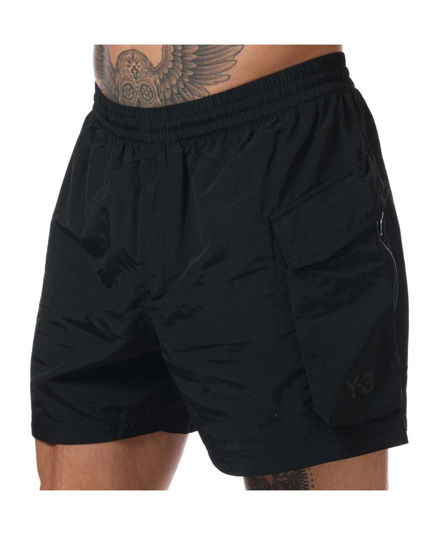 Mens Y-3 Utility Swim Shorts in black.- Drawcord on elastic waist.- Snap-button cargo pocket.- Zip leg pocket.- Zip back pocket.- Tonal Y-3 logo.- 100% Polyester. Machine washable.- Ref: GT5256
