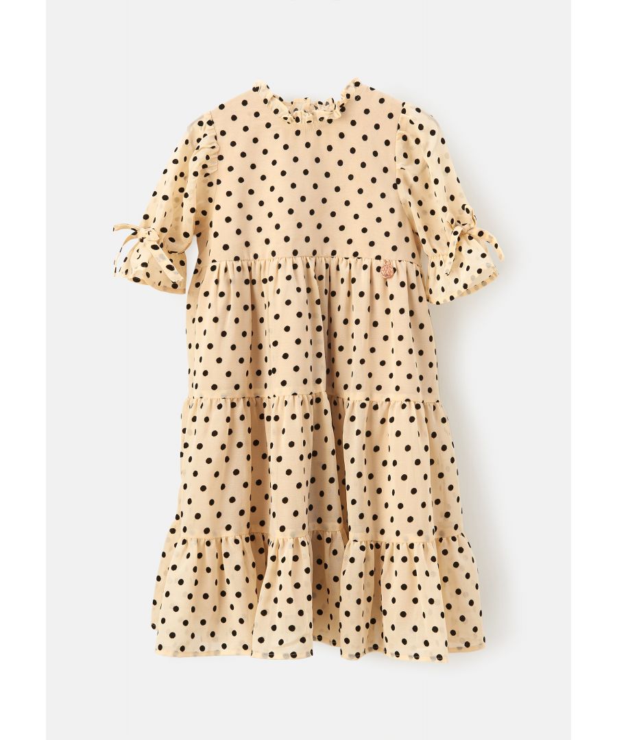 Make this spotty tiered dress your new favourite. A flocked black spot on an ivory georgette  with a ruffle neckline and tiered skirt.Wear with your trainers for comfort and style.Angel & Rocket cares – made with recycled polyesterAbout me: 100% polyesterLook after me – Think planet  wash at 30c
