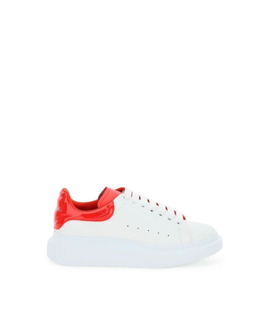 Alexander McQueen leather sneakers with oversized rubber sole and leather lining with removable insole. Wavy patent heel tab with silver-tone logo print, painted metal eyelets, contrasting leather tongue with silver-tone logo print and side perforations. Extra laces included.