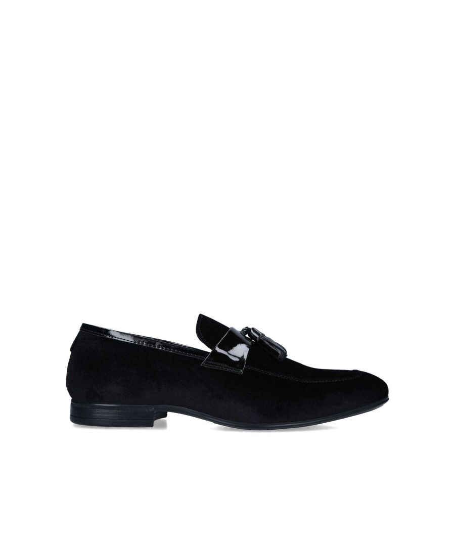 The Stevie Velvet is a formal slip on shoe in black velvet. The vamp is topped with patent strap with two tassel details.