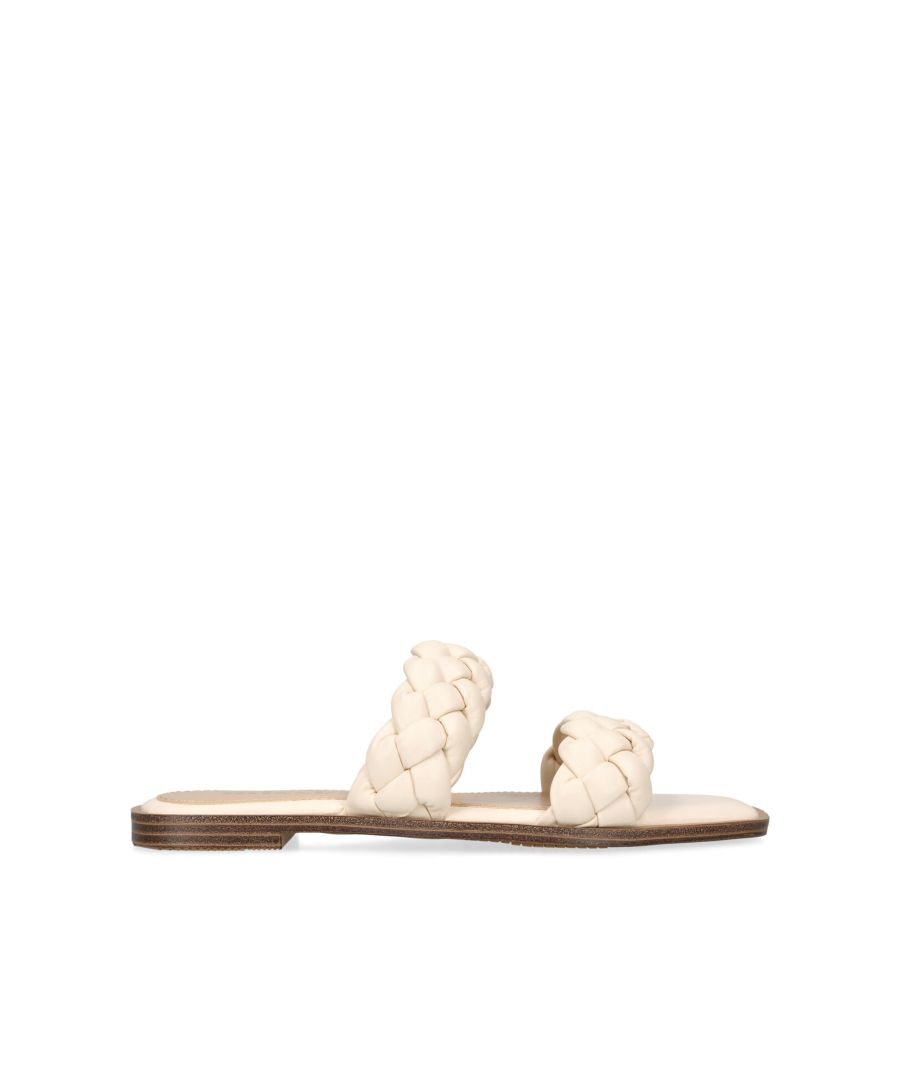 The bone Pauli from Miss KG is a flat sandal with two braided straps across the foot. The footbed is padded for comfort.