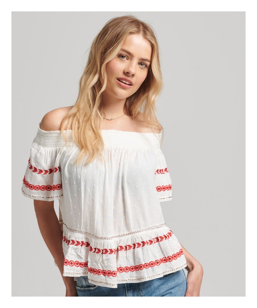 There's a definite bohemian feel to our off-the-shoulder top, one that's taken influence from the history of the Americas but is perfect for your holiday. Beautiful embroidery and beadwork adorn the slubbed viscose fabric to give an authentic feel. Lace inserts add to the intricacy while the peplum hem gives extra flow and movement to this classic piece.Loose Fit – where comfort meets cool, a stylish loose cut makes this a must-have shapeElasticated necklineIntricate embroideryBeadwork embellishmentsLace inserts and trimSubtle Superdry logo badge