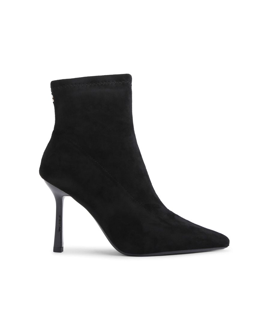 The Attention Ankle Boot features a black microsuede upper and stiletto heel in black. There is a small, golden Icon C stud at the back of the ankle.