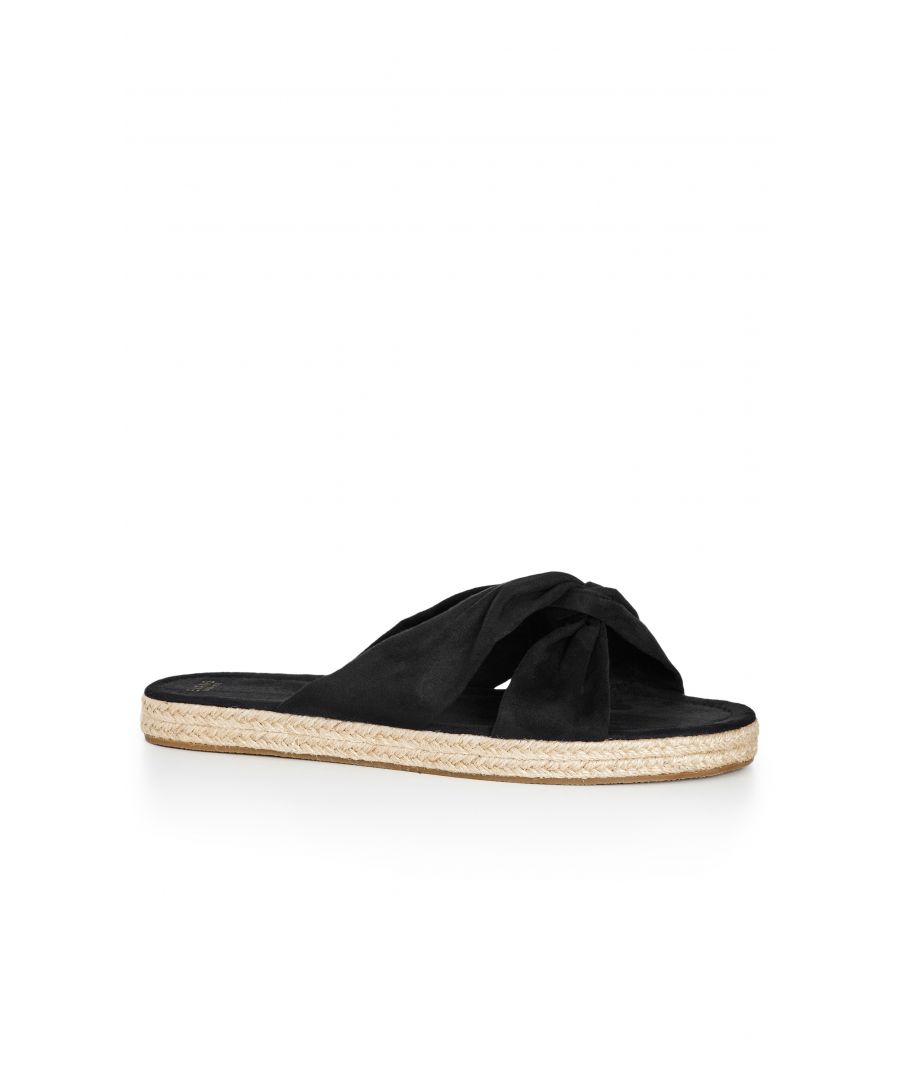 Feel dreamy in the daily comfort of the black Softie Knot Flatform. A faux suede finish is kept casual with a woven flatform sole and knot strap detailing, slipping on in an easy extra wide fit. Key Features Include: - Open toe - Knotted toe strap - Faux suede fabrication - Slip on style - Extra wide fit - Chunky woven flatform sole