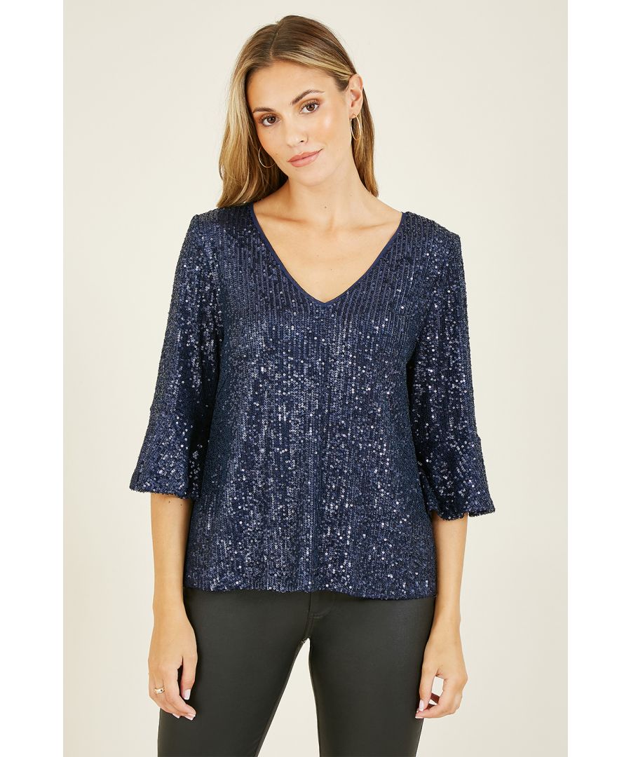 Out out has never felt so good! This stunning Yumi Navy Sequin Relaxed Fit Top is stylish and flattering, perfect for parties. With all-over, navy sequin detailing, this relaxed fit top is fully lined, fusing comfort with style. Features super flattering fluted sleeves and a peep hole back fastening. Match with skinny black jeans or leather trousers to complete the look.