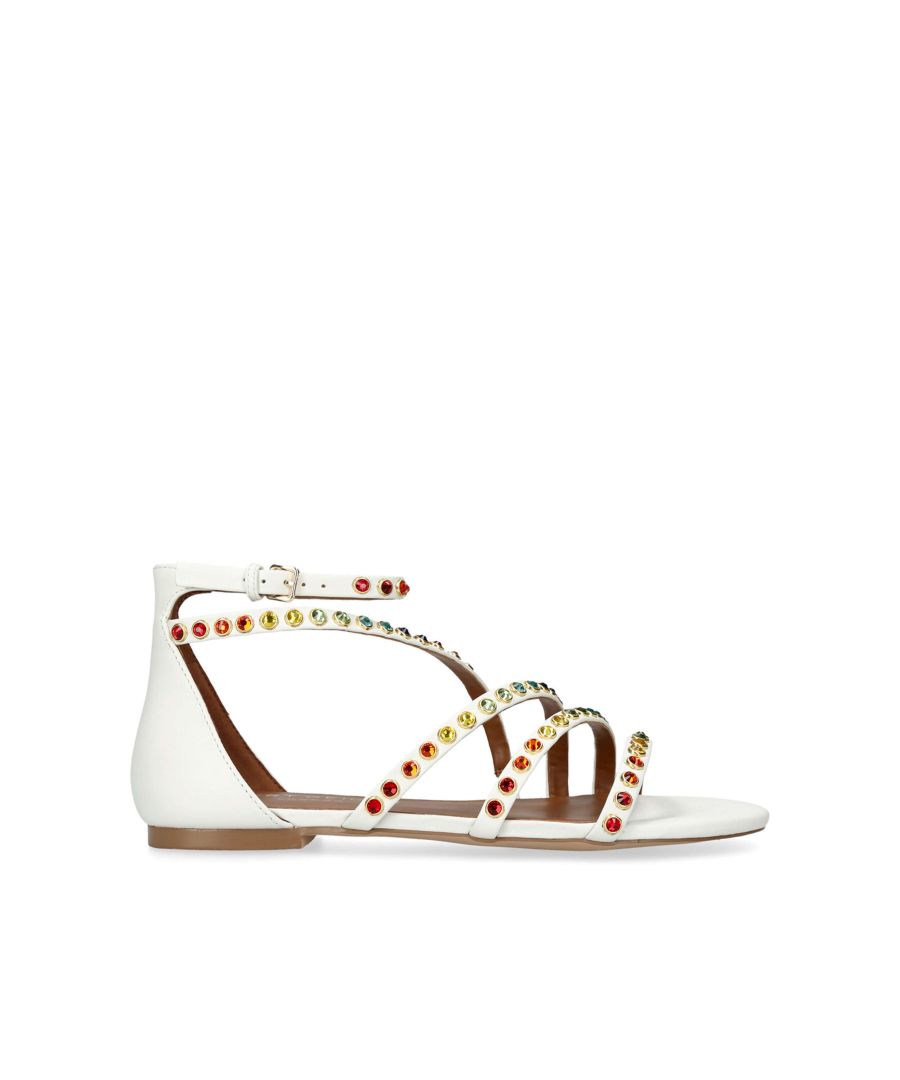 The Kurt Geiger London Hyde is a flat sandal crafted from a bone leather. Each of the straps are embellished with multi-colour crystals.