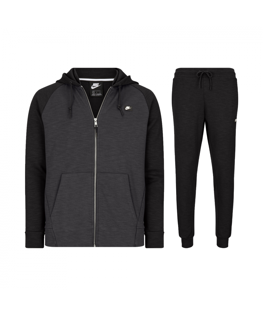The Nike Optic Zip Tracksuit is designed with a full zip fastening and drawstring hood for a perfect fit which will keep you protected from the elements, the open hand pockets are great for storing valuables or keeping your hands warm. The fleece jogger pants have an elastic waistband for added comfort and a sleek design for an elegant fit from the hips to the hem. \nMade from a smooth fabric this tracksuit is sure to provide all-day comfort while the Nike Swoosh logo ensures a recognisable finish to the design.\nStandard fit\nFull zip fastening\nPanelled hoodie, with adjustable hood\n2 front open pockets\nRibbed hem and cuffs\nElastic waistband with drawcord stretches for comfort\nTapered fit and cuff design\nZippered back pocket for secure storage offers space\nOuter stitched hand pockets provide convenient storage\nDouble knit fabric offers a soft feel and comfort\nRubber Nike corporate logo patch heat-applied to the hip and chest\n62% Cotton, 38% Polyester\nMachine Washable