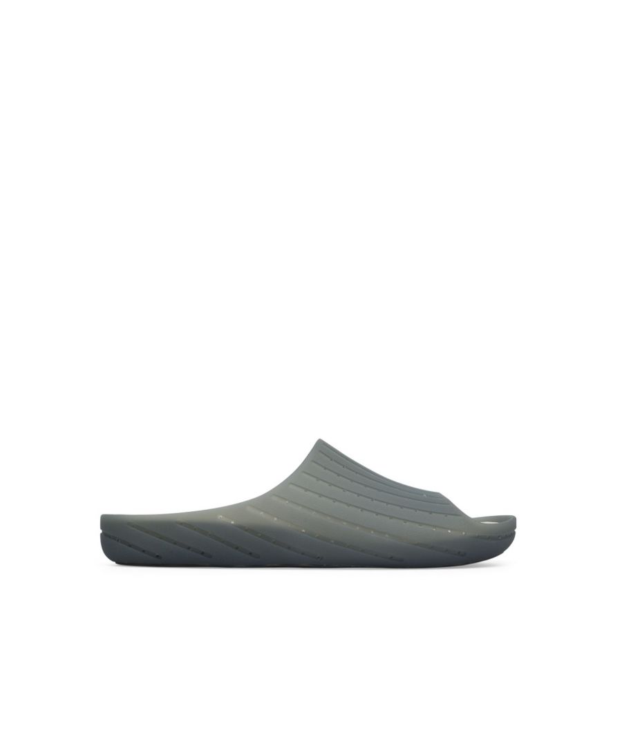 Monomaterial Wabi sandal made of 20% recycled TPU and 100% recyclable in grey for men. PU removable footbed.\n\nA Little Better, Never Perfect \n\nOur iconic Wabi slippers are inspired by Japanese minimalism and encourage us to focus on the now. Made with the idea of keeping components and production processes to a minimum, these men's slippers continue to redefine indoor comfort more than twenty years after their debut with soft cushioning and a cozy feel.