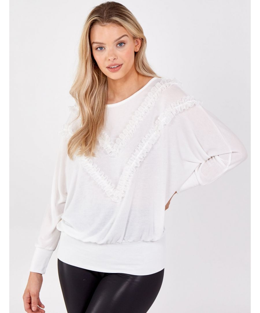 Get perfect balance between casual and smart look with this pearl batwing top. With its oversized fit it and ruffle detail its a perfect addition to any wardrobe.    \nConstruction: Body: 97% Polyester, 3% Elastane; Trim: 100% Polyester. Hand Wash Only. Approx. Length: 62cm .