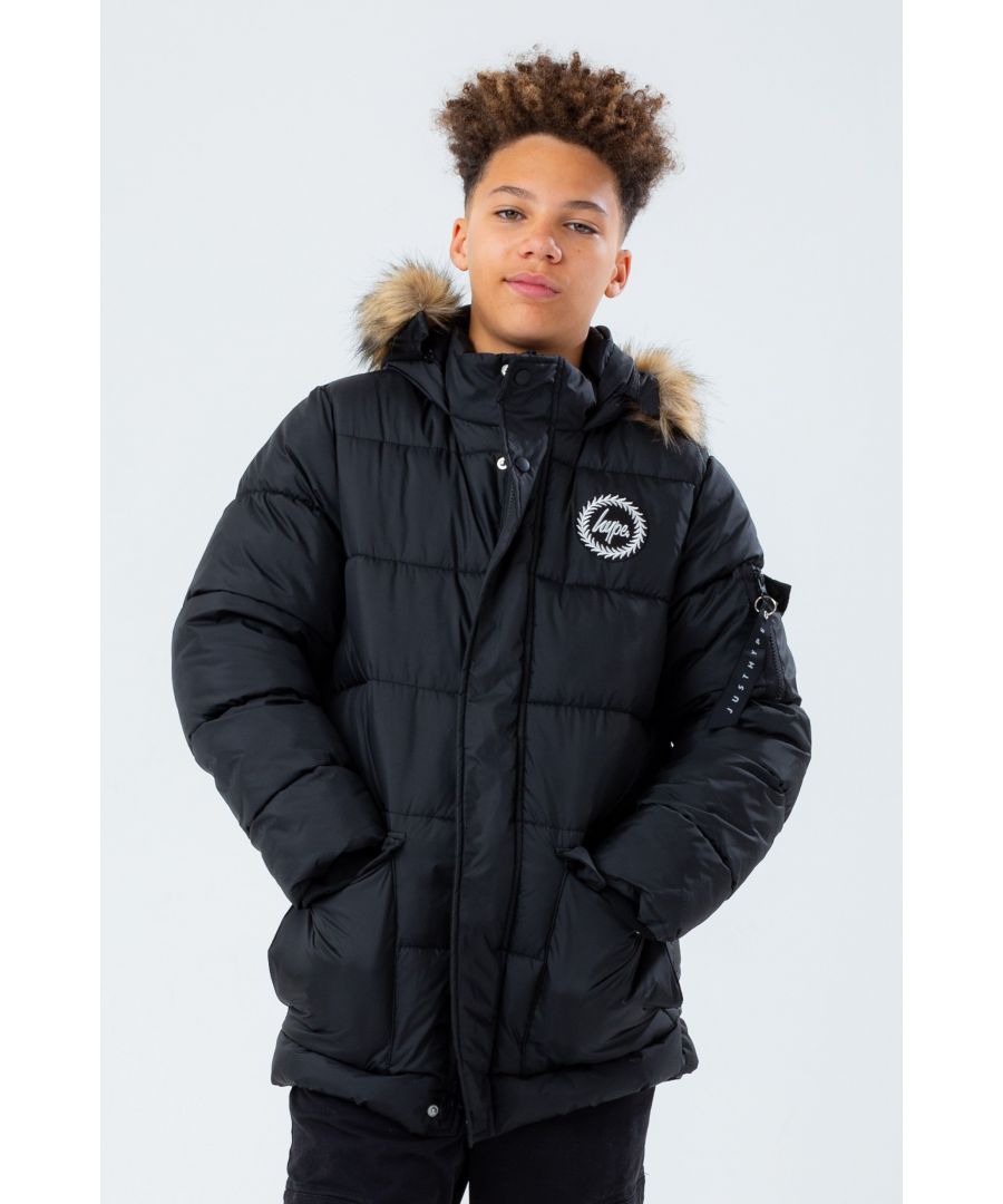 The Hype. Black Core Kids Explorer Jacket is the perfect kids coat you need this winter. Designed in our standard explorer puffer shape in a classic black, with a removable brown faux fur hood trim. Finished with an embossed MA1 pocket zip puller on the sleeve pocket. With the iconic HYPE. crest badge logo in a contrasting monochrome on the front. Machine washable.
