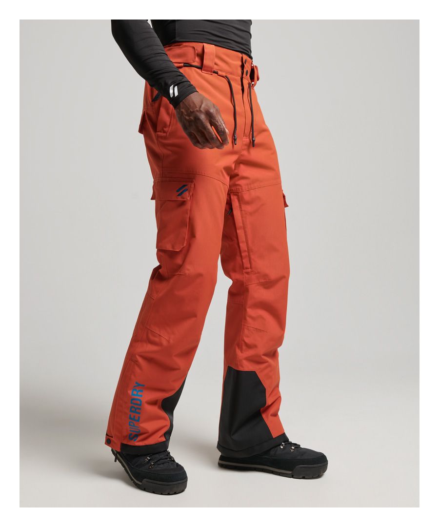 Get ready to hit the slopes with our Ski Ultimate rescue pants. Adjustable features allow you to customise these pants to suit your individual needs, no matter how you aim to tackle the cold weather. Carefully chosen properties can help to keep you shielded from the elements so that you can confidentially layer up and push yourself to your goals in reliable comfort. A minimalistic approach to the design allows you to effortlessly pair these pants with any outfit so you can create your own understated yet elevated style - even in the snow. Finished with subtle branding to tie the look together.Relaxed: A classic fit. Not too slim, not too tight – no distractions hereBreathable 20k/MM - Provides airflow comfort for very high-level activityWaterproof 20k/MM - Waterproof under high pressure, for heavy rain and wet snowDurable water repellency - This fabric has been coated with an advanced water-resistant finishFully taped seams - Seams have been internally taped to help prevent water penetrationStraight legBelt loopsDrawstring waist with hook and loop adjustersPopper and hook and loop fastened waistbandZip fasteningInside seam zip ventsTwo popper fastened leg pocketsElasticated snow cuff with hook and loop fasteningZip and popper cuffAnti scuff panelTwo popper fastened back pocketsWaistband and seat lined with soft touch fabricPrinted silicone brandingEmbroidered S logoThe RECCO reflector in this product enables rescue professionals to locate you with RECCO detectors in the event of an avalanche accident or when lost in the outdoors.The padding in these pants is 100% recycled, each pair of pants contains up to 20 recycled bottles, this avoids these bottles being sent to landfill or polluting our oceans.
