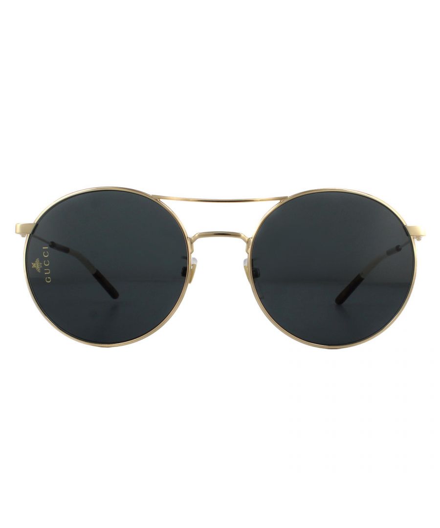 Gucci Sunglasses GG0680S 001 Gold Grey have a lightweight metal frame with a double bridge joining the round shaped lenses in a fashionable modern style. The adjustible nose pads and plastic temple tips allow for an all day snug fit. Interlocking GG logo appears along the temples and the Gucci logo on the left lens for brand authenticity.