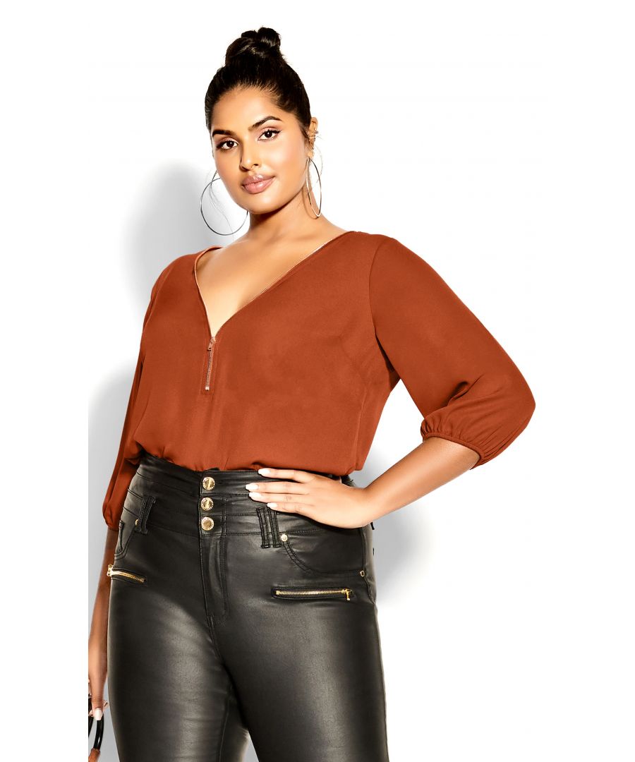 The ginger Sexy Fling Elbow Sleeve Top is a seriously stylish staple for your wardrobe. Its functional zip v-neckline, elbow length sleeves and relaxed fit are perfect to elevate your everyday outfit. Key Features Include: - Workable zip neckline - Darted bust - Double layer front - 3/4 sleeve with elastic cuff - Relaxed fit - Hip length hemline - Lightweight woven fabrication